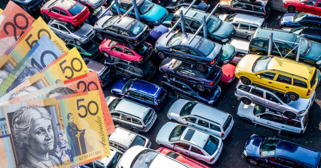 Car wrecking yard with cars stacked on top of each other and money being offered.