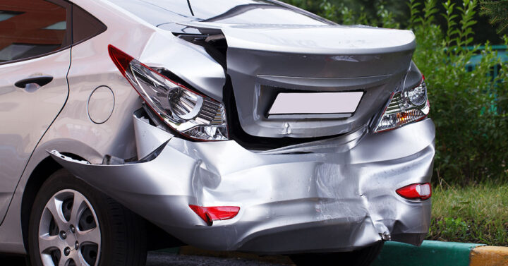 Grey car with badly damaged rear end.