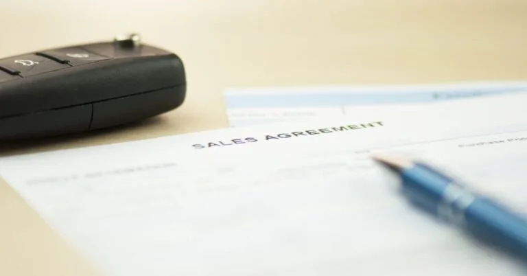 Car keys on the signed agreement sale document.
