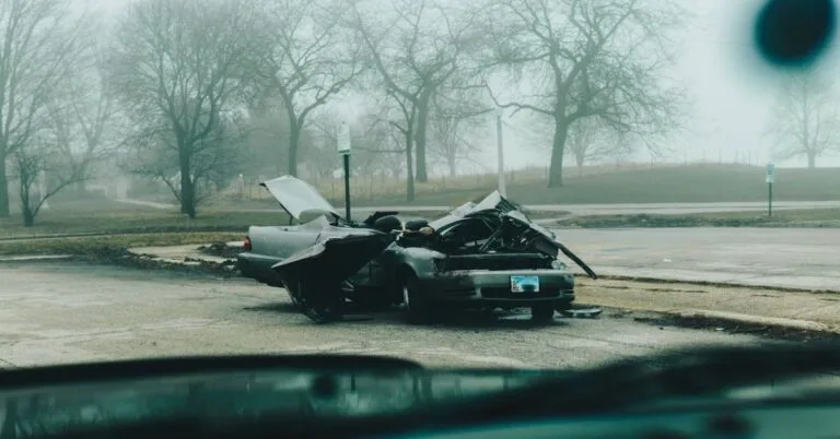 A Wrecked Car Parked Outside.